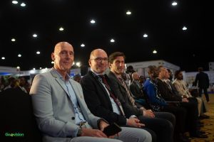 Men seated at a conference event
